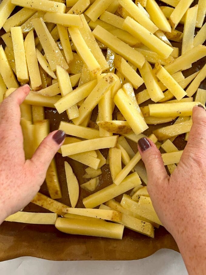 How to make homemade chips step two. Lay on baking tray and put on olive oil, salt and pepper and garlic granules.