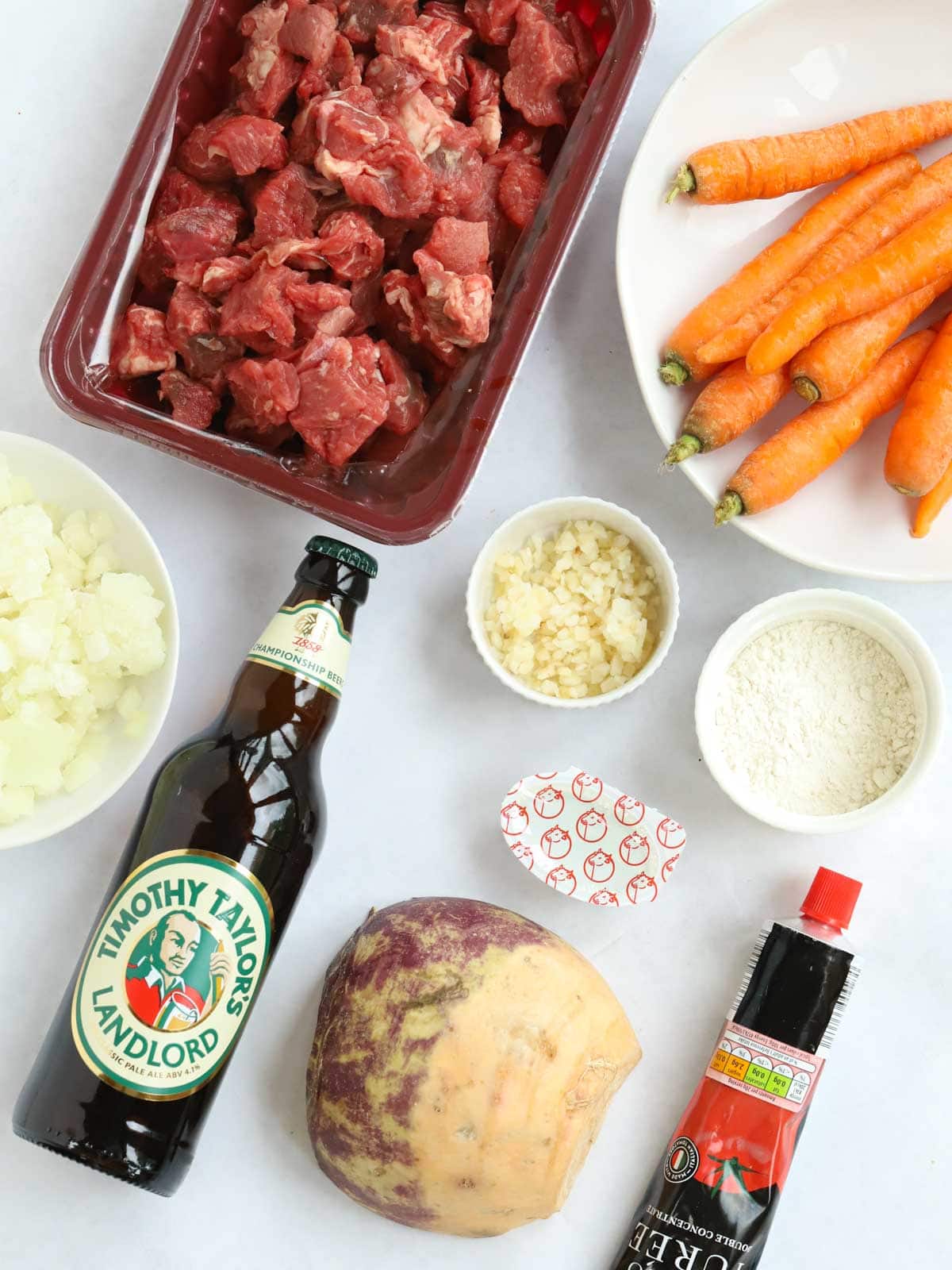 Ingredients for a slow cooker beef casserole laid on a counter.
