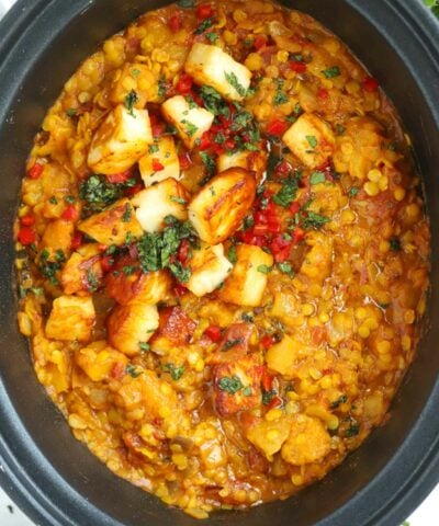 A finished Slow Cooker Dahl recipe topped with paneer and coriander.