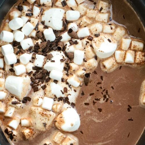Gooey, rich, creamy hot chocolate made in the slow cooker, topped with marshmallows and sprinkles.