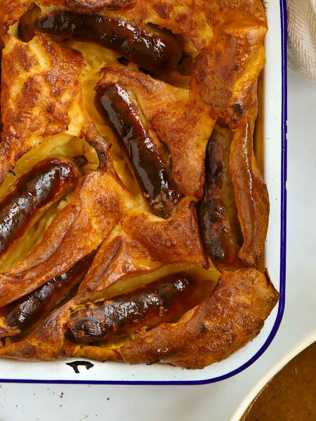 Close up of a tray of Toad in the Hole - sausages in Yorkshire Pudding - for a recipe.