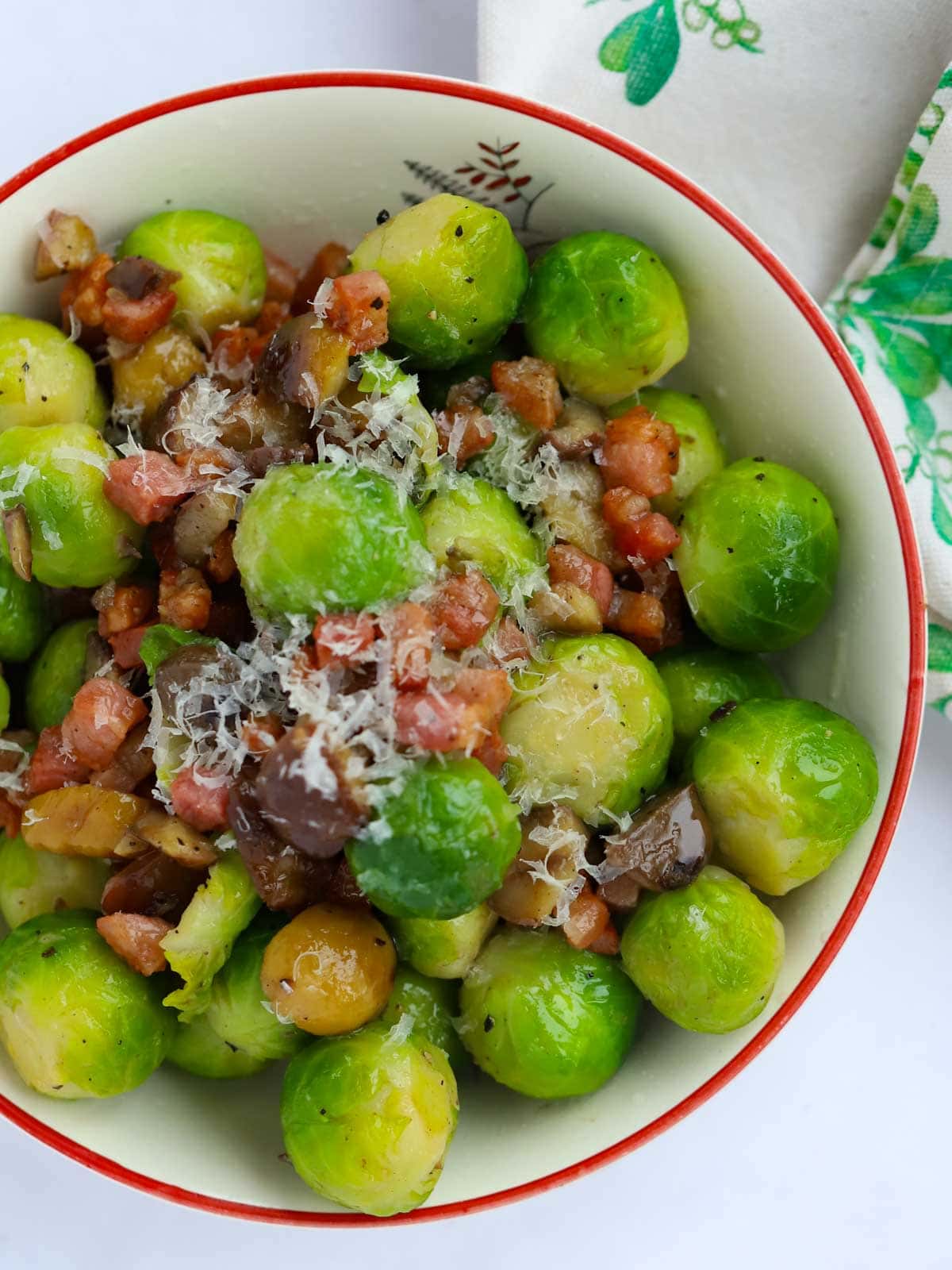 A bowl of Brussels Sprouts and Bacon with parmesan on top.