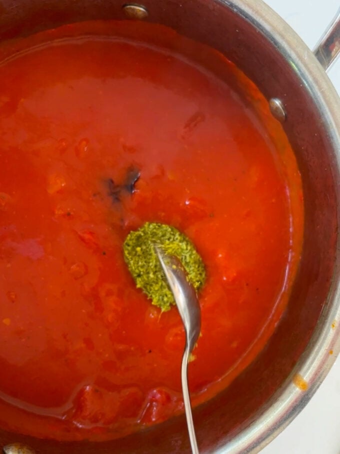 Making tomato soup with pesto.