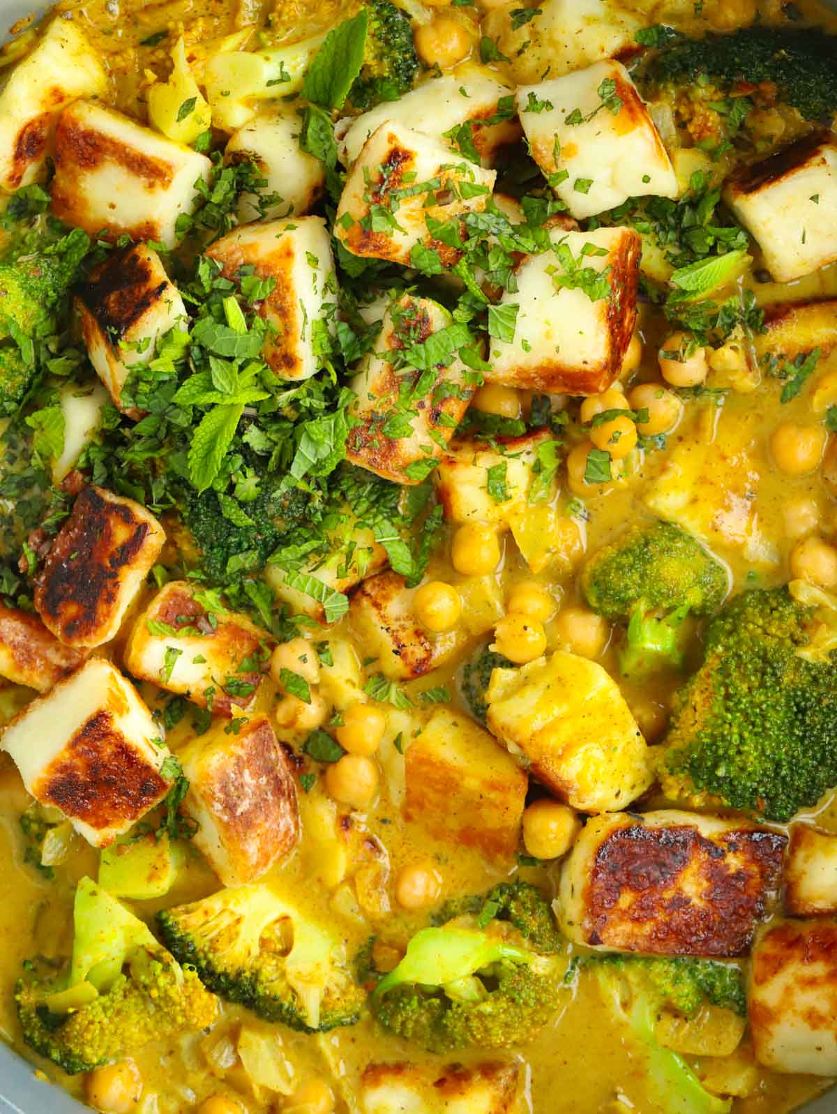 Close up of a Halloumi Curry with chickpeas and broccoli.