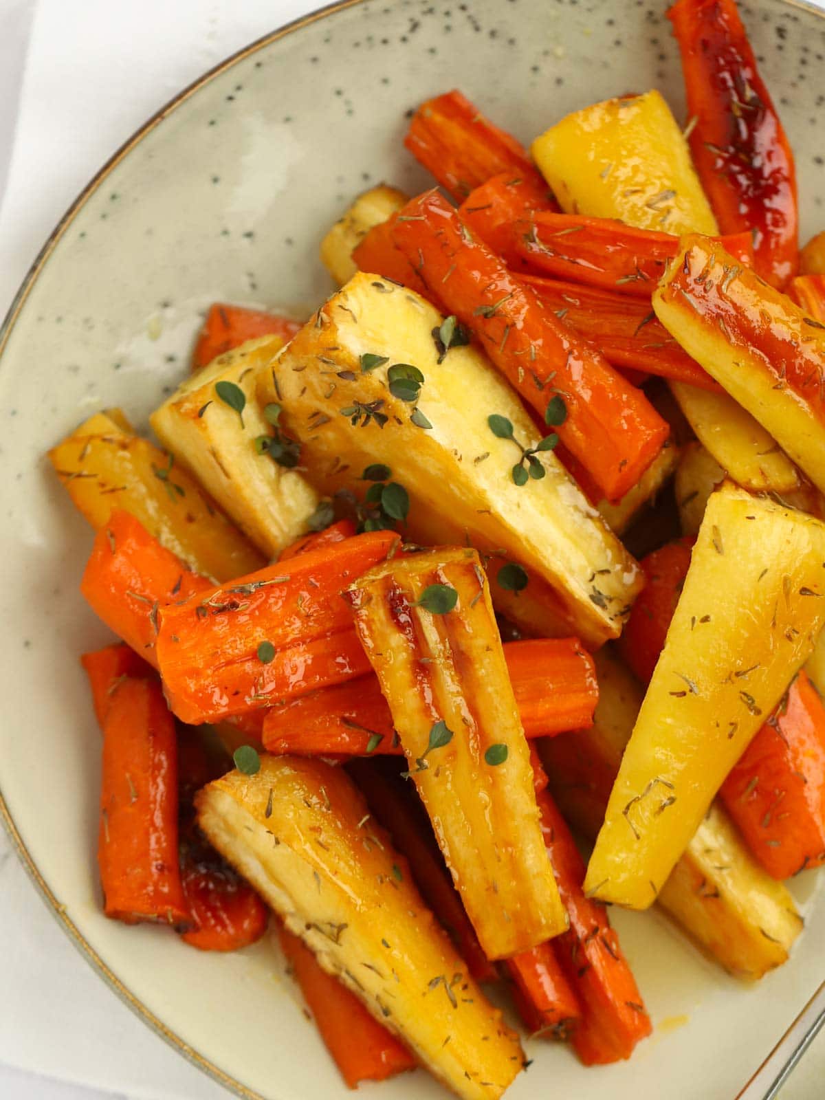 Recipe for Honey Roasted Carrots and Parsnips on a plate.