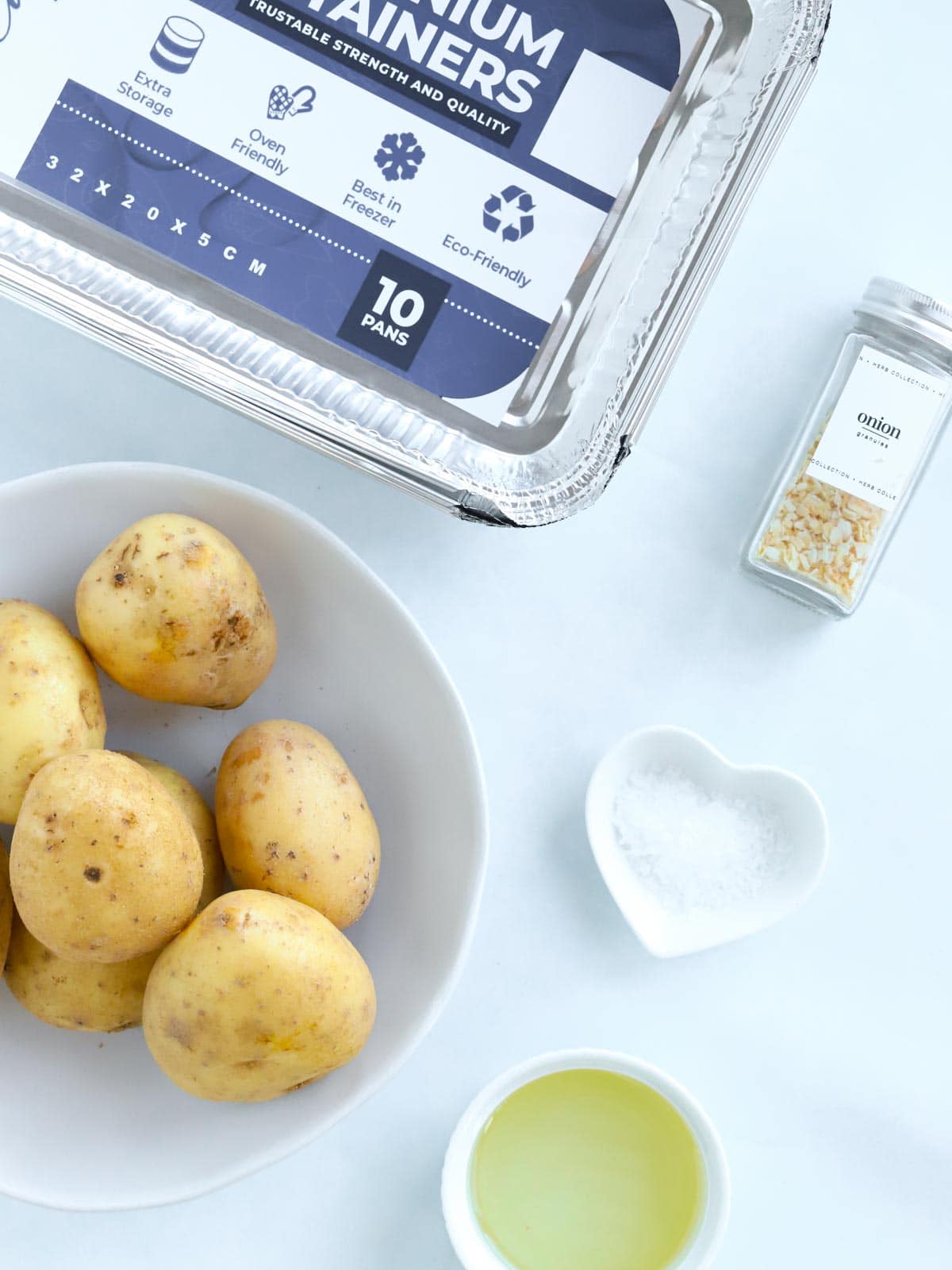 Easy Roast Potatoes recipe ingredients all laid out on a counter.