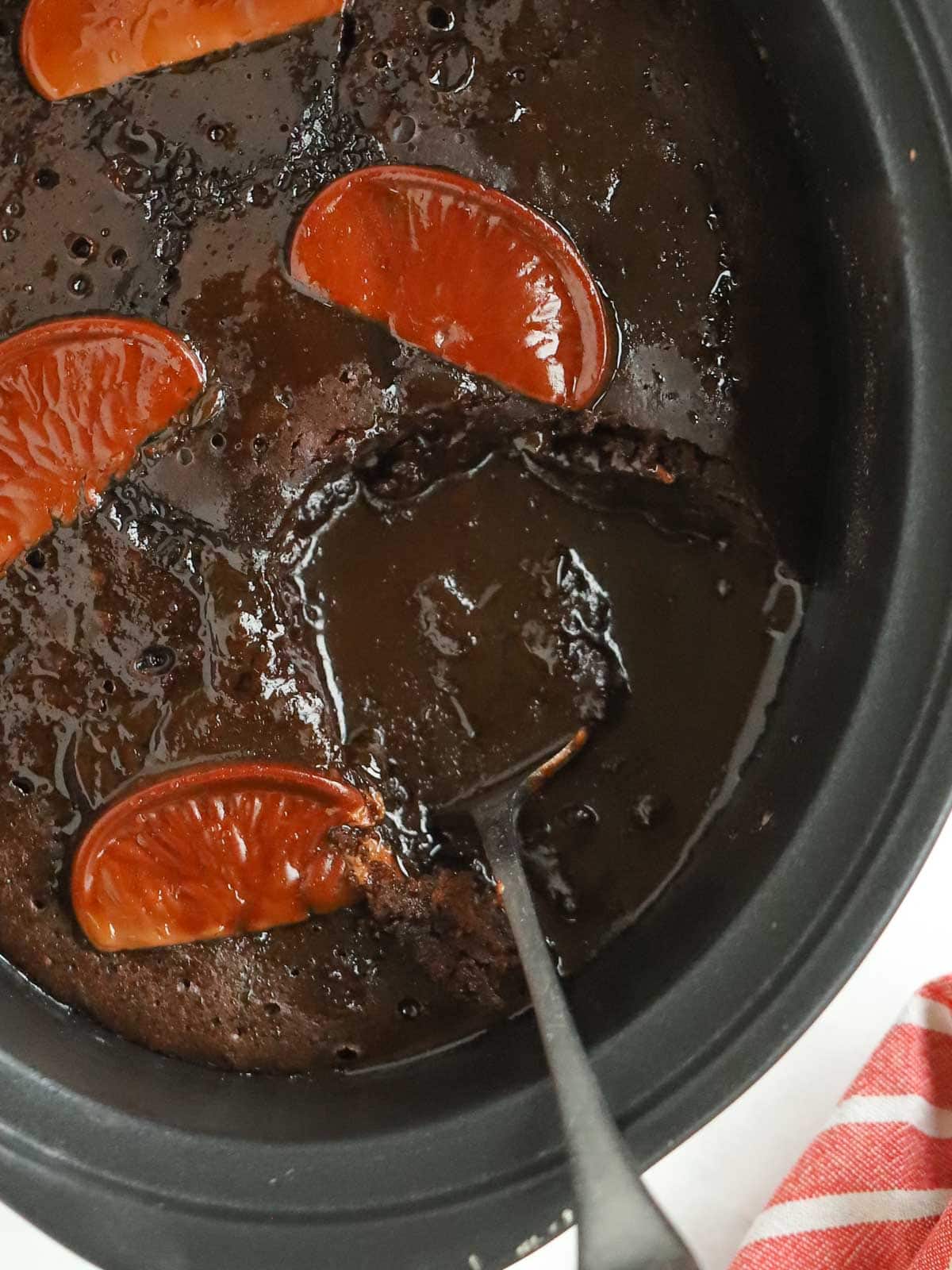 Close up of slow cooker pan with chocolate orange pudding inside.