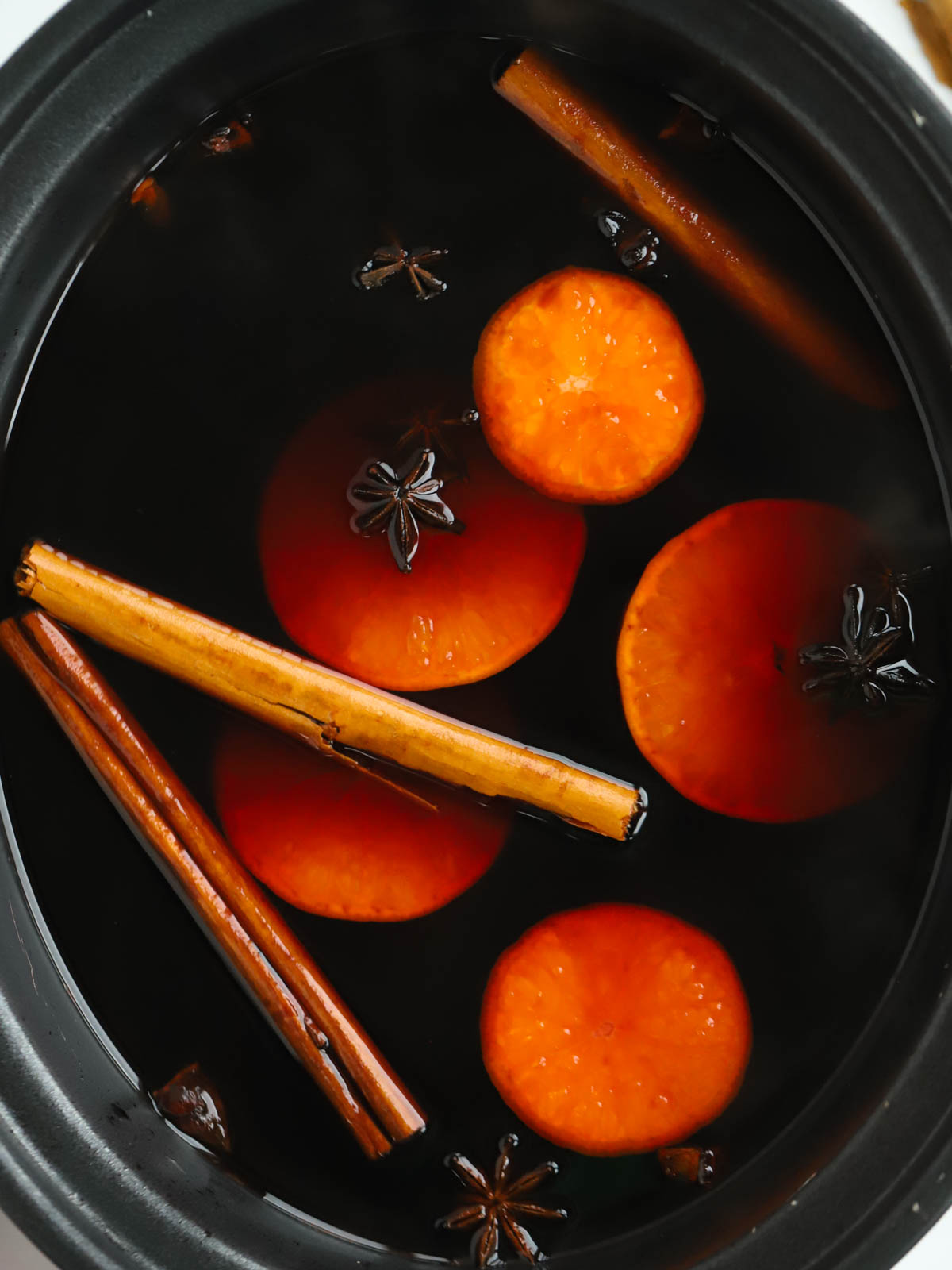 Close up of a slow cooker filled with Mulled Wine.