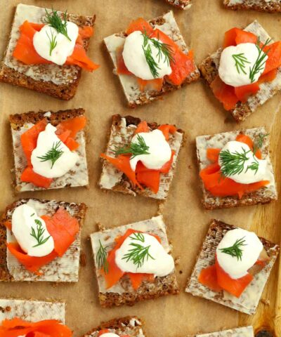 Perfect party food on a serving board. Smoked Salmon Canapés topped with creme fraiche and dill.