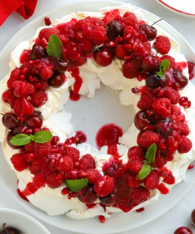The perfect Christmas dessert for decorating the table. A Christmas Wreath Pavlova.