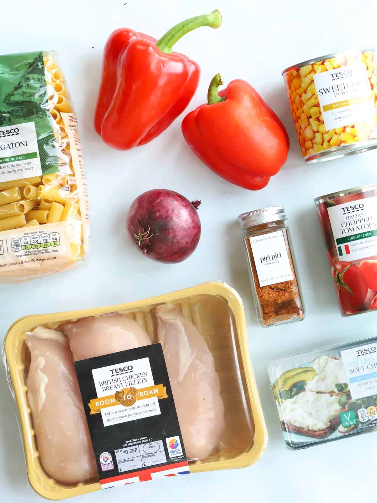 Ingredients for peri peri chicken pasta laid on the table.