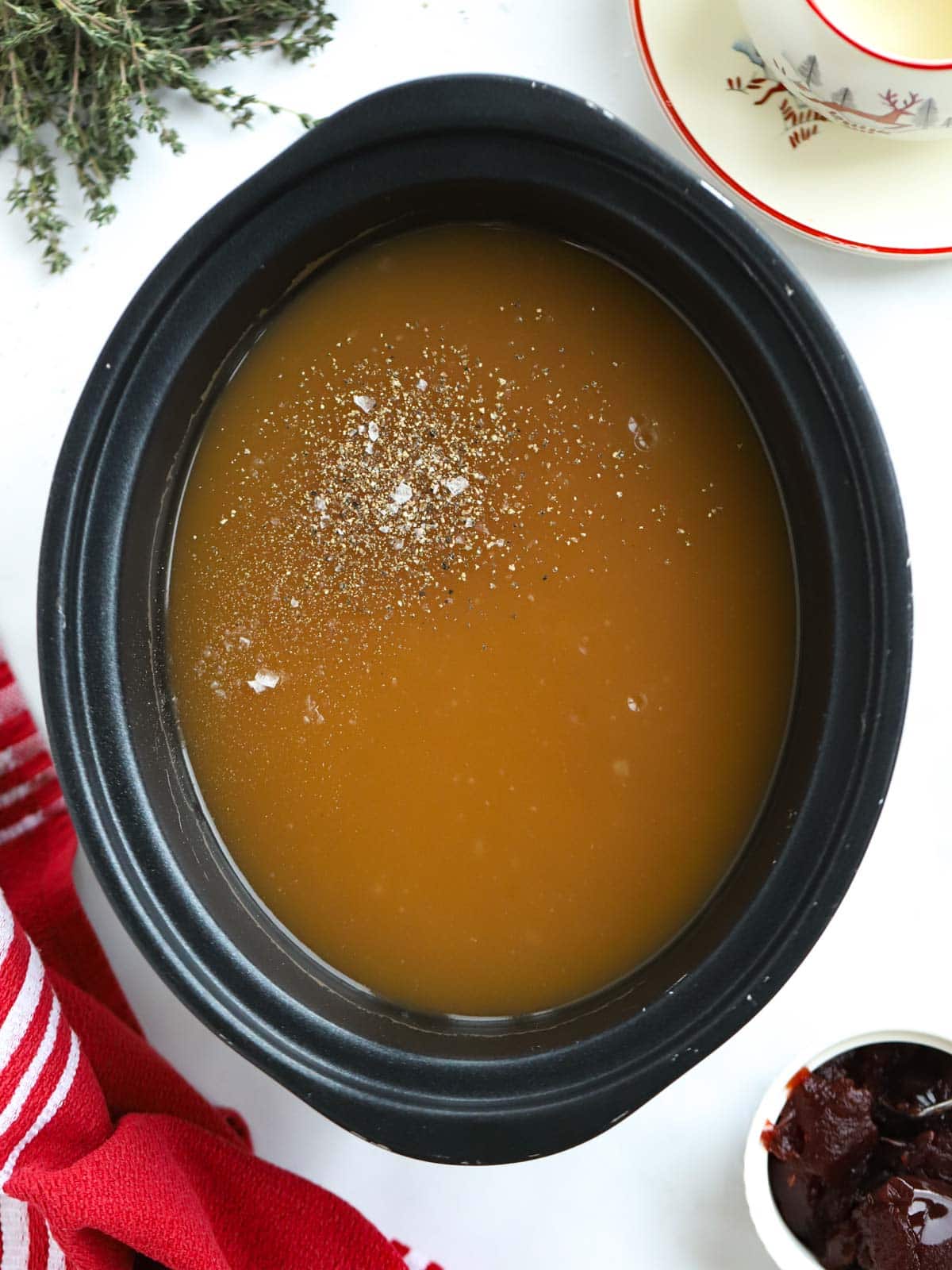A slow cooker filled with make ahead gravy, which is perfect for Christmas or a big meal.