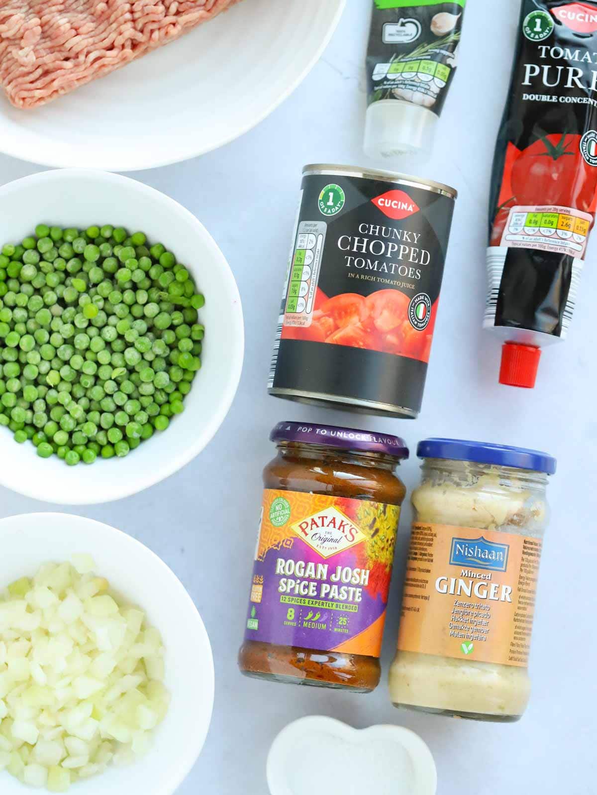 Ingredients for a lamb keema curry laid out on a counter top.