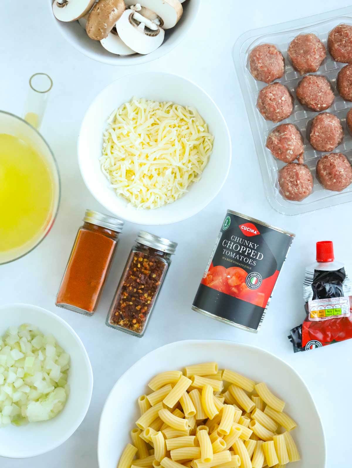 Meatball pasta bake ingredients laid on a counter.