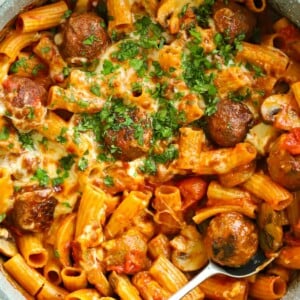 Recipe for Meatball Pasta Bake with ready-made meatballs and pasta, topped with cheese in a tomato sauce.
