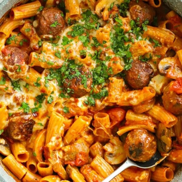 Recipe for Meatball Pasta Bake with ready-made meatballs and pasta, topped with cheese in a tomato sauce.