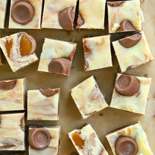 Squares of no-bake Rolo Fudge on a tray.