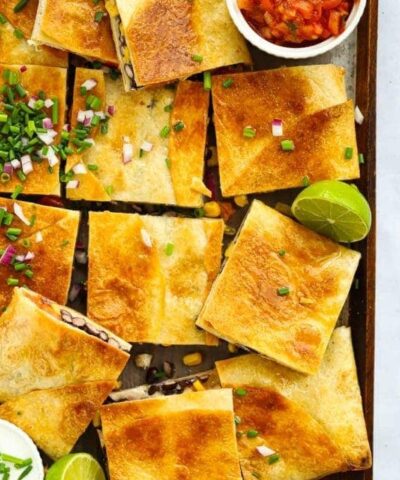 Chicken Quesadillas cut into squares with lime and salsa.