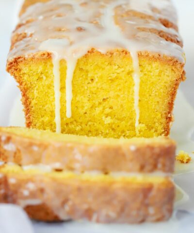 The best lemon drizzle cake recipe. Baked and sliced on a plate.