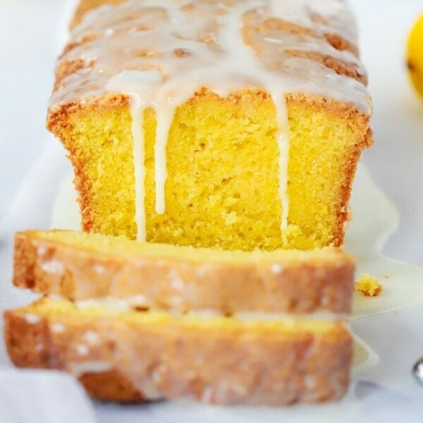 The best lemon drizzle cake recipe. Baked and sliced on a plate.