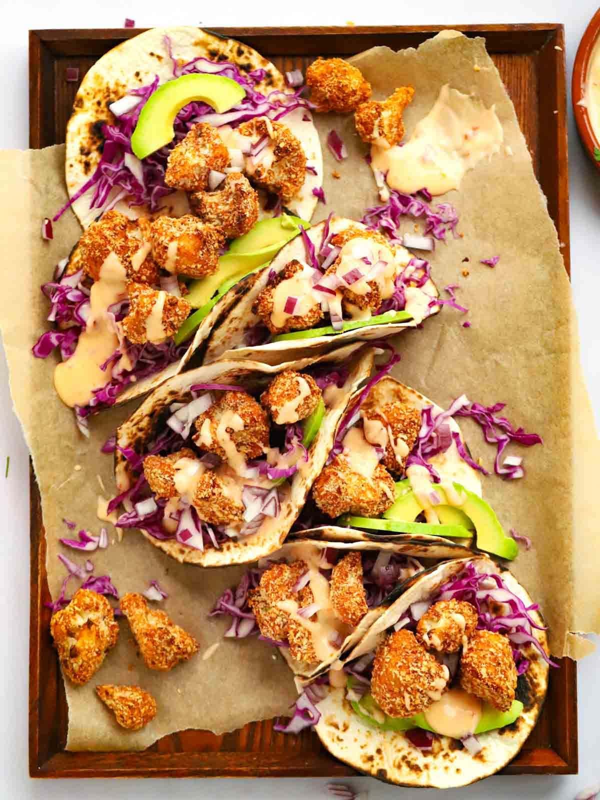 Cauliflower Tacos placed together on a tray, ready for sharing.