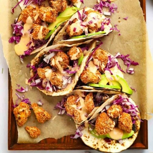 Delicious crispy Cauliflower Tacos on a tray, ready to be eaten.