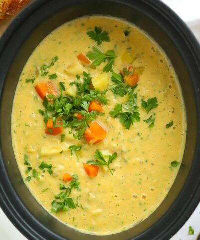 Bit slow cooker pan full of creamy vegetable soup.