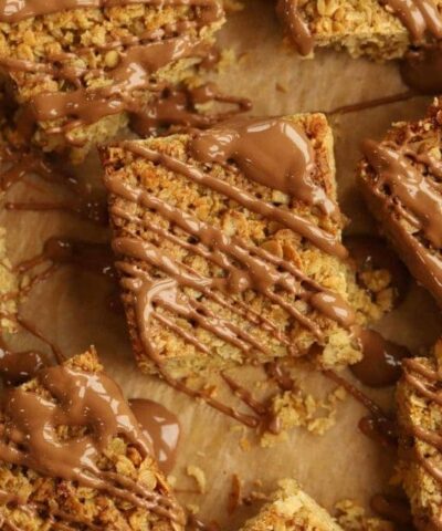 Squares of flapjack drizzled with chocolate.