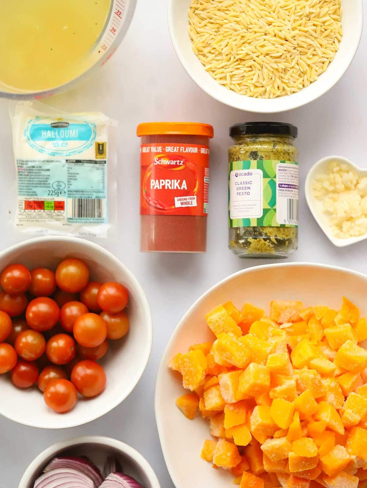 Ingredients for Butternut Squash and Halloumi Orzo Bake laid on a counter.