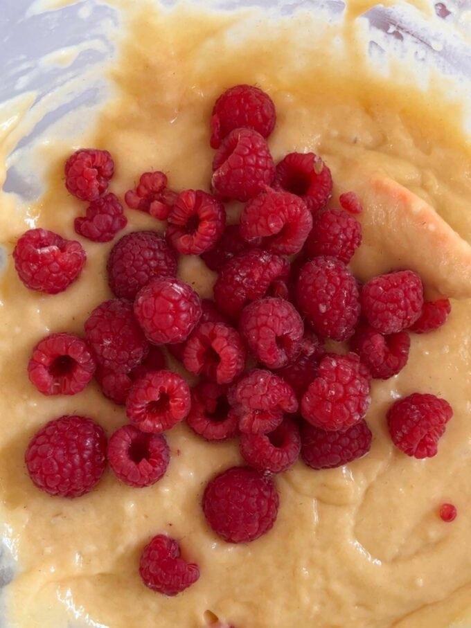 Raspberries about to be stirred into the cake mixture for Yoghurt Pot Cake recipe.