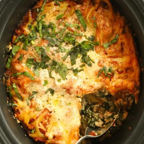 Slow cooker lasagne filled with spinach and ricotta, topped with cheese.