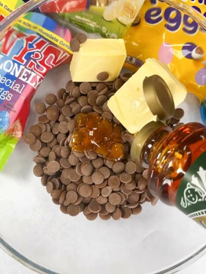 Step 1 ingredients in a bowl for the Easter Rocky Road recipe. Milk chocolate, butter and gold syrup.
