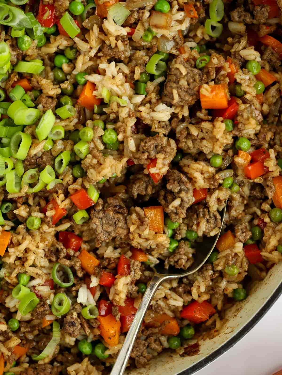 Chinese Beef Fried Rice dish close up with a spoon ready to serve.