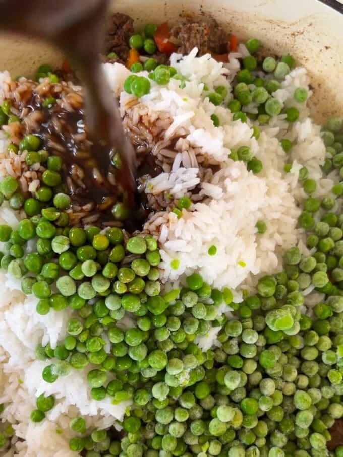 Rice and peas with mince and sauce in a pan to make up the recipe for Beef Fried Rice.