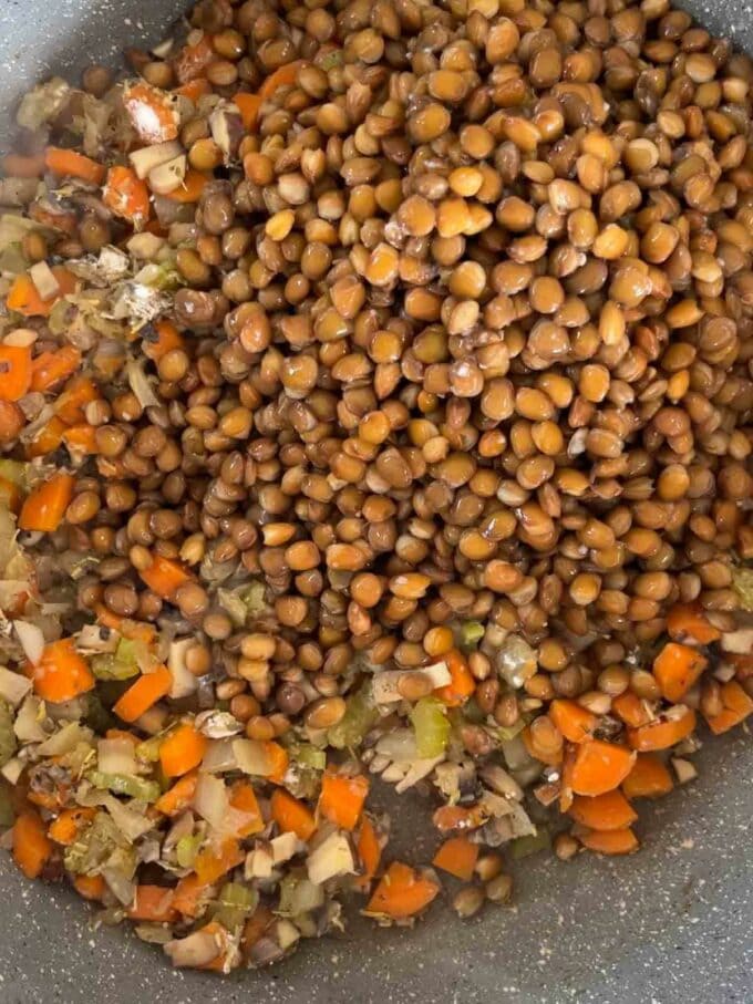 Step 1 in the recipe for Vegetarian Cottage Pie. Add lentils and vegetables and to a pan and fry.