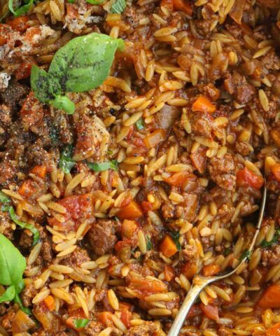 A close up of a big dish of beef orzo with bolognese.
