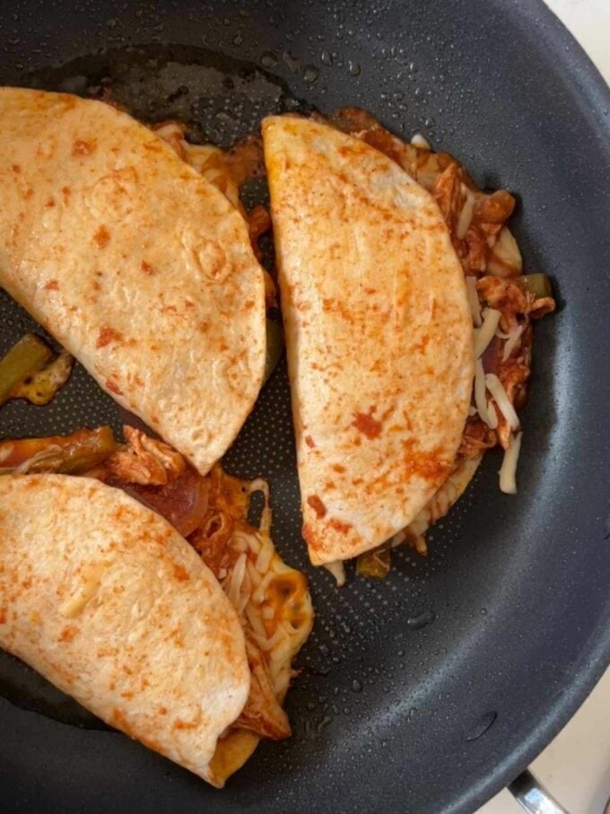 Chicken Tacos being fried in a pan.