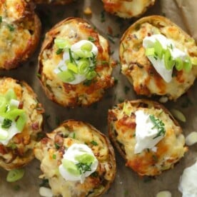Loaded potato skins with bacon and cheese, topped with sour cream and chives.