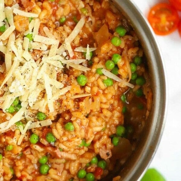 Baked Risotto recipe with bacon and cheese and peas, all in a big pan.