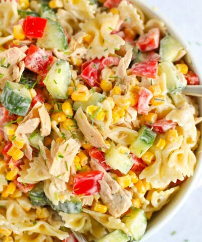A big bowl full of tuna pasta salad, with cucumber, sweetcorn and red pepper.