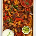 A baking tray with chicken oven fajitas ready to eat.