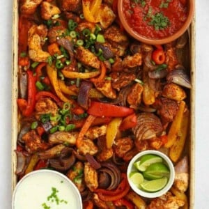 A baking tray with chicken oven fajitas ready to eat.