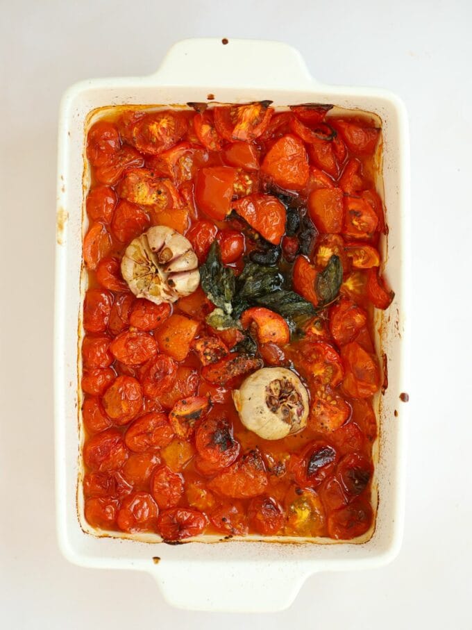 Roasted tomatoes, garlic and basil ready to turn into a rich pasta sauce.