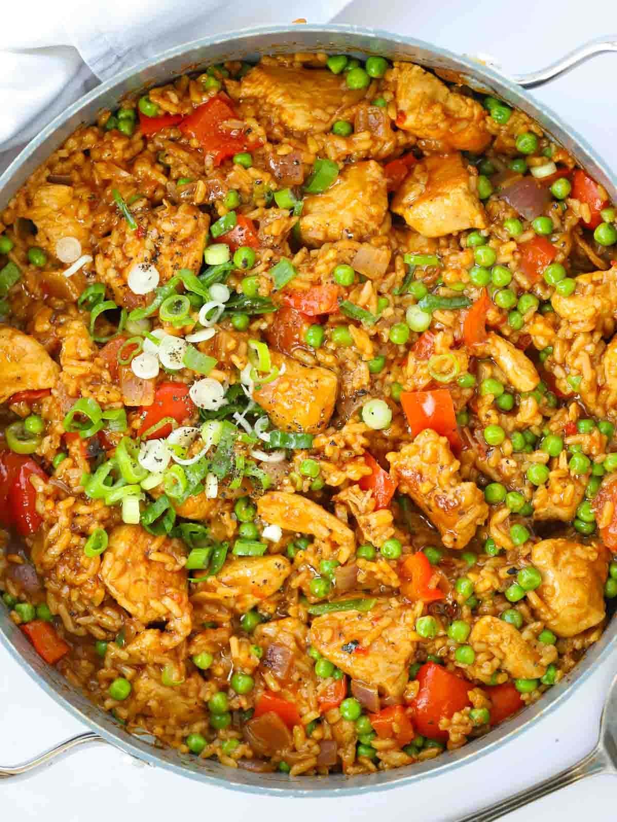 One big pan filled with cooked Peri Peri Chicken and Rice. A big family dinner.