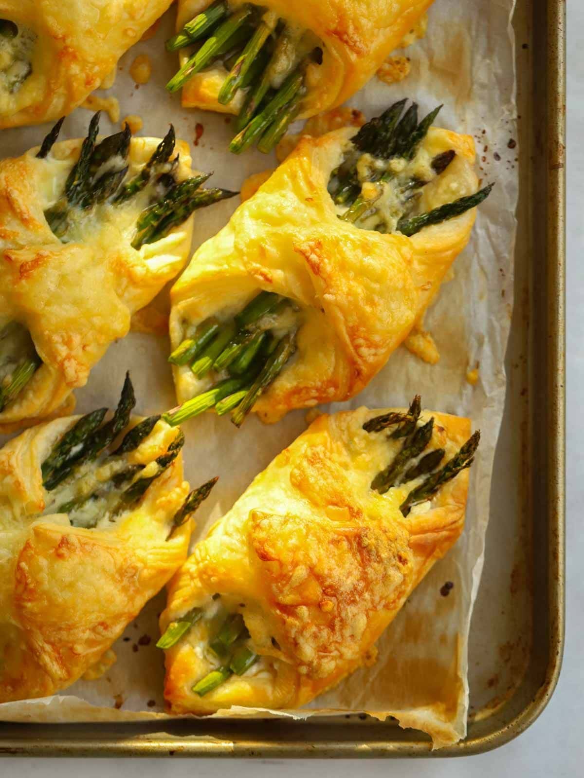 Puff pastry parcels wrapped with asparagus and cheese filling.