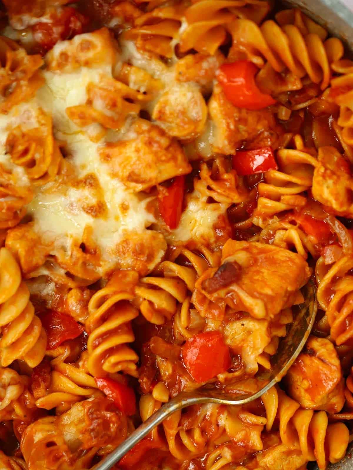 A close up of cooked BBQ chicken pasta.