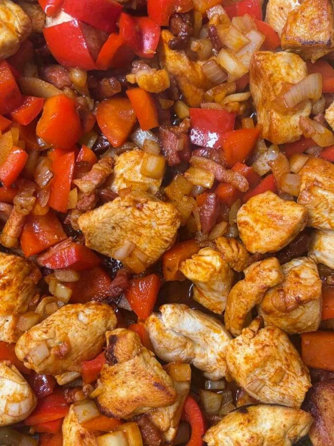 Step 2 in the recipe for BBQ Chicken Pasta. Fry the vegetables in with the cooked chicken and bacon.