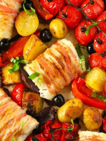 A tray bake of delicious white fish of cod wrapped with pancetta and potatoes and tomatoes.