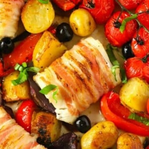 A tray bake of delicious white fish of cod wrapped with pancetta and potatoes and tomatoes.