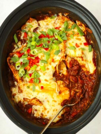 Slow cooker filled with beef enchiladas.